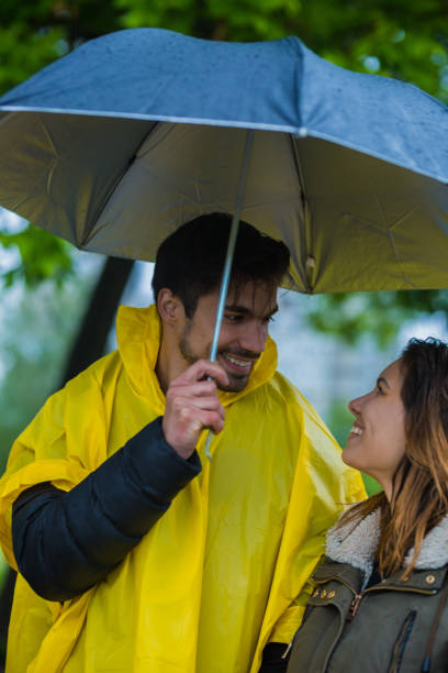 istock Couple under umbrella during rainy spring day 1149242793