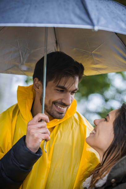 istock Couple under umbrella during rainy spring day 1149242870
