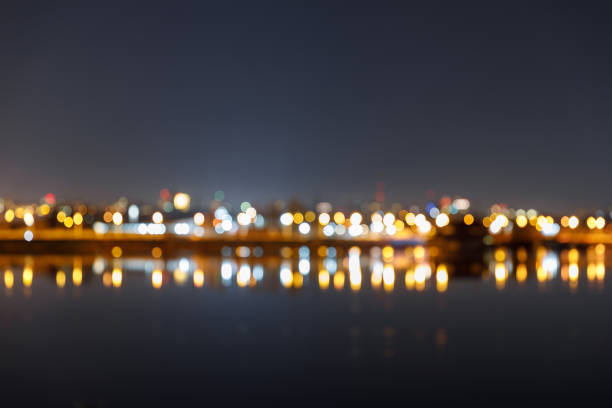istock dark cityscape with defocused illuminated buildings and river 1149242891
