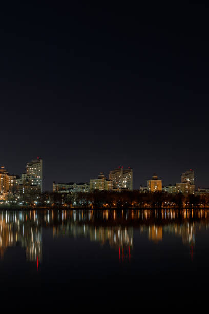 istock illuminated buildings with reflection on water at night 1149242912