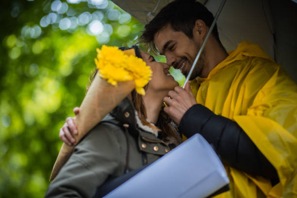 istock Couple under umbrella during rainy spring day 1149243620