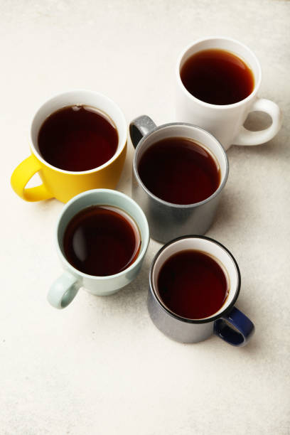 istock Black tea (coffee) in bright cups, office break, team building 1149243746