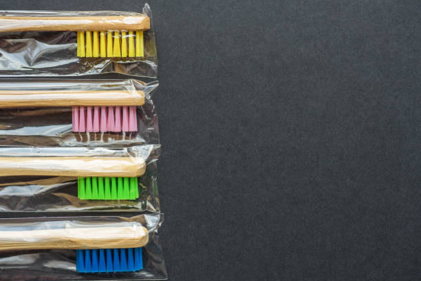 istock bamboo toothbrushes in plastic bags on dark rough background. plastic-free concept 1149243788
