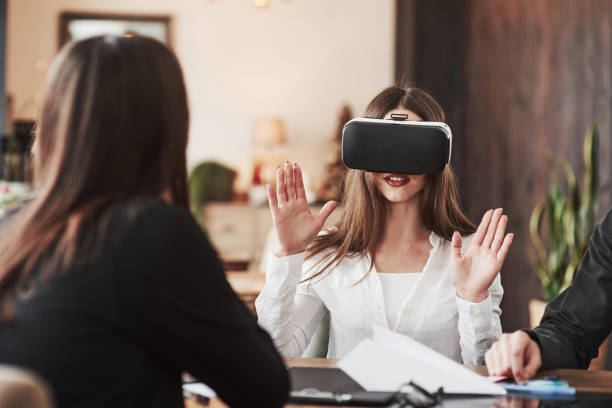 istock Trying to touch virtual objects. Having fun in the office room. Friendly coworkers playing around at their break time 1149243887