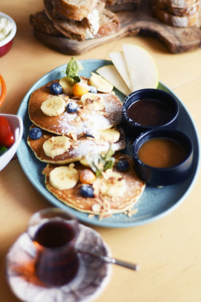 istock Delicious breakfast with pancakes and tea on a table 1149243934