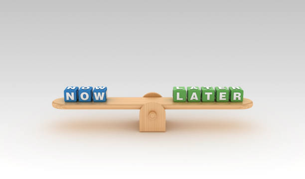 istock Seesaw with NOW LATER Buzzword Cubes - 3D Rendering 1149243985