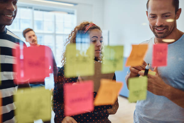 istock Designers brainstorming together with sticky notes in an office 1149244415