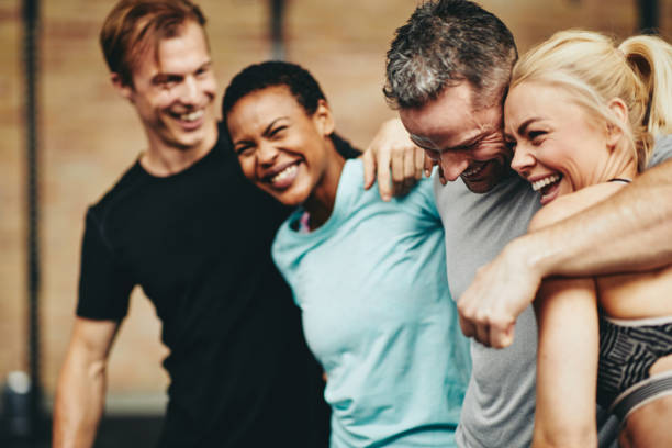 istock Diverse friends laughing together while standing in a gym 1149245766