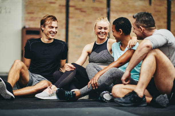 istock Laughing friends sitting in a gym after working out 1149245784