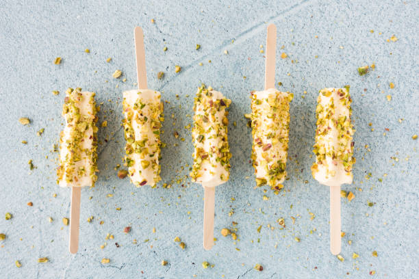 Mango And Pistachio Kulfi Lollies On Blue Cement Background Stock Photo -  Download Image Now - iStock