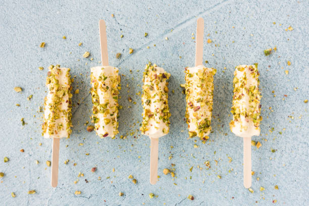 Mango And Pistachio Kulfi Lollies On Blue Cement Background Stock Photo - Download Image Now - iStock Mango And Pistachio Kulfi Lollies On Blue Cement Background Stock Photo - Download Image Now - iStock