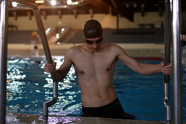 istock Male swimmer going into the pool 1149248481