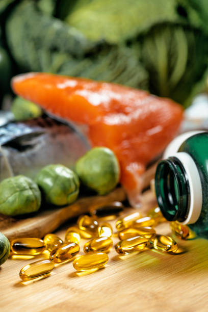 omega 3 gel capsules and natural sources of omega 3 - fish oil vegetable capsule healthy eating imagens e fotografias de stock