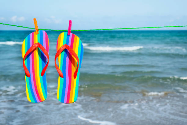 rainbow flip-flops hanging on a clothes line