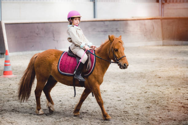 istock beautiful young girl on her pony 1149251847