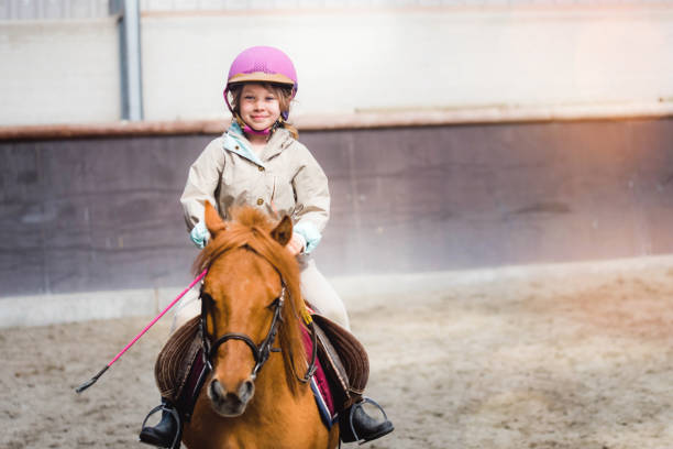 istock beautiful young girl on her pony 1149251945