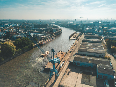 Wide panoramic drone view over Elbe river with industrial port of Hamburg