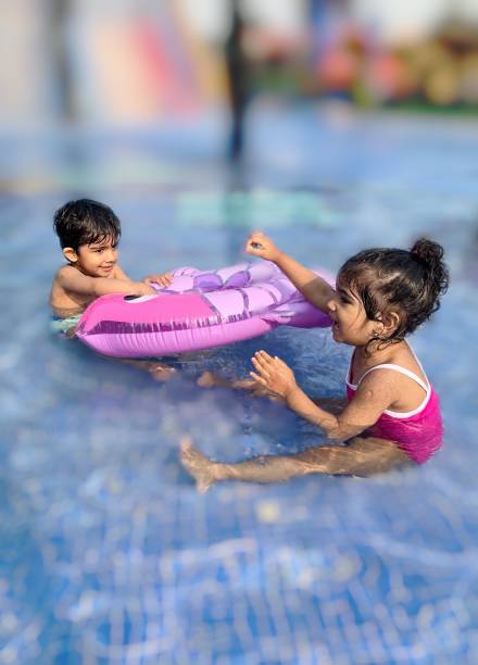 istock Indian kids playing in swimming pool in summers 1149255756