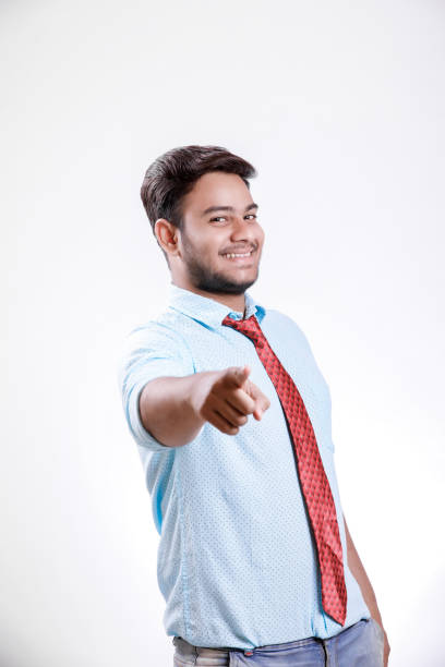 istock Handsome young Indian man standing isolated over white background 1149258596