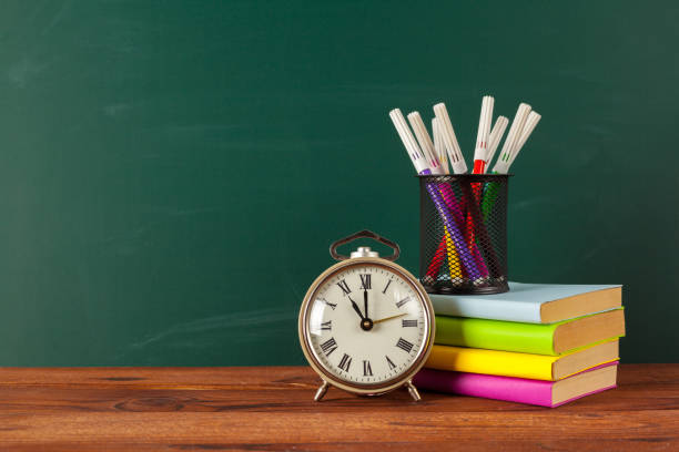 istock School supplies on a wooden table and blackboard 1149258609