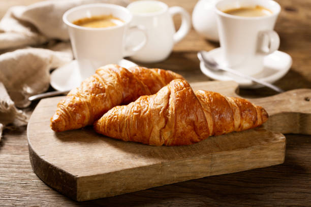 istock breakfast with cups of coffee and croissants 1149259708