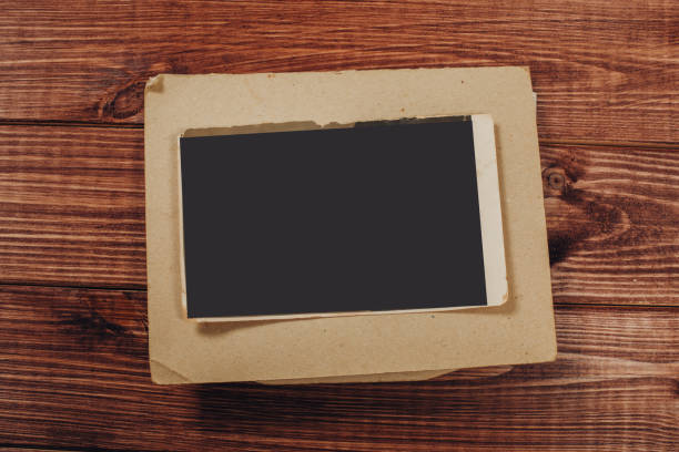 istock Stack old photos on table. Mock-up blank paper. Postcard rumpled and dirty vintage. Retro card 1149260036