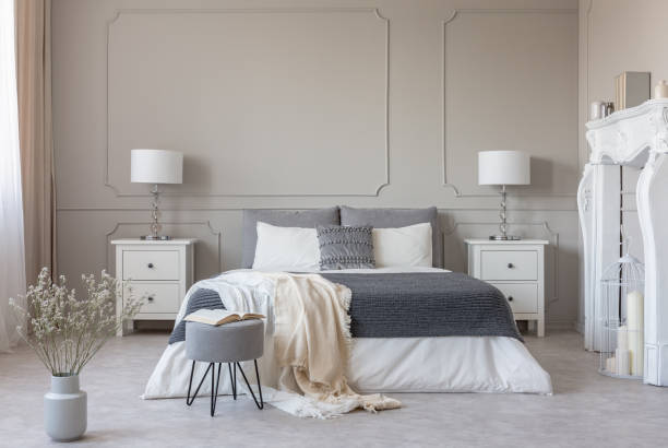 istock New york style bedroom interior with symmetric design, copy space on empty grey wall 1149261797