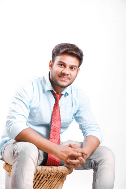 istock Handsome young Indian man siting on table isolated over white background 1149263113