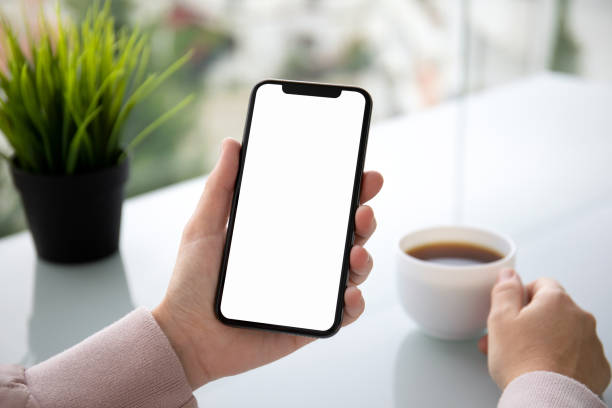 istock female hand holding touch phone with isolated screen in cafe 1149264692