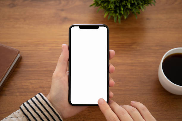 istock female hand holding touch phone with isolated screen in office 1149265398