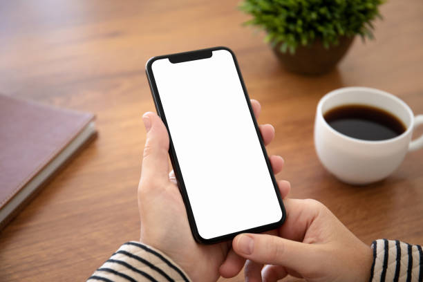 istock female hand holding touch phone with isolated screen in office 1149265598