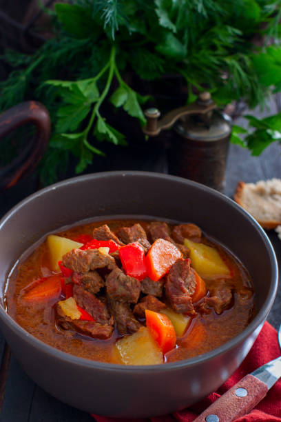 istock Traditional Hungarian goulash on a wooden table, selective focus 1149265795