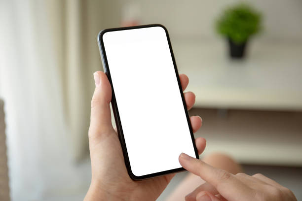 istock female hands holding phone with isolated screen in room 1149265832