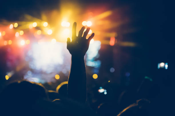 istock Cheering crowd at concert enjoying music performance 1149266100