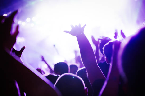 istock Cheering crowd at concert enjoying music performance 1149266126