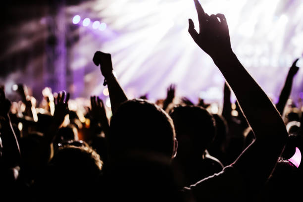 istock Cheering crowd at concert enjoying music performance 1149266135