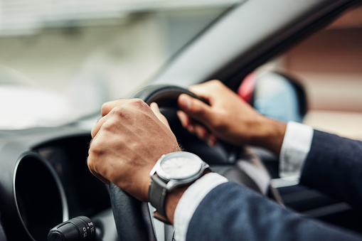 Cropped shot of an unrecognizable man's hands on a steering wheel