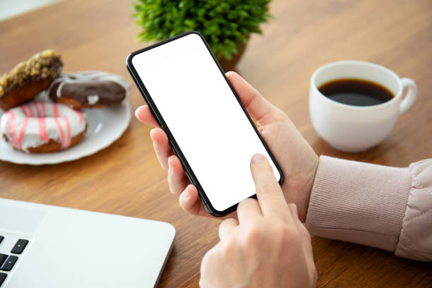 istock female hands holding phone with isolated screen in the office 1149267339