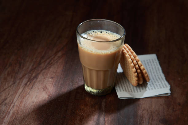 istock A glass of tea and biscuits on a wooden table. 1149267509