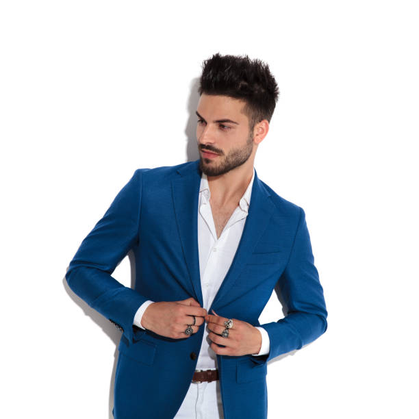 istock Handsome guy looking to the side and fixing his jacket 1149267880