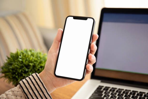 istock female hands holding touch phone with isolated screen in office 1149268088