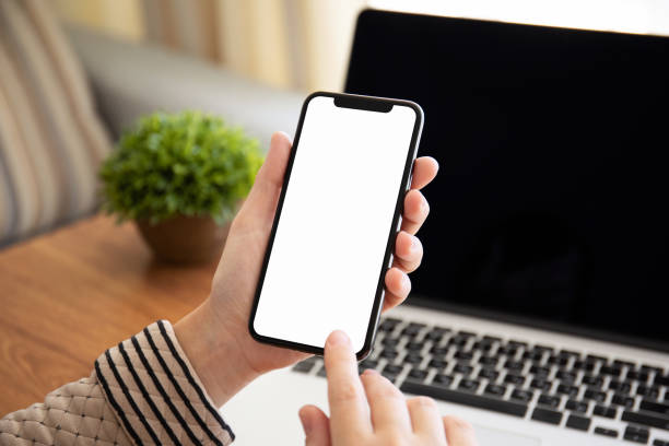 istock female hands holding touch phone with isolated screen in office 1149268122