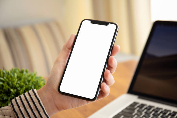 istock female hands holding touch phone with isolated screen in office 1149268738