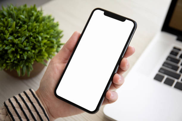 istock female hands holding touch phone with isolated screen in office 1149268762