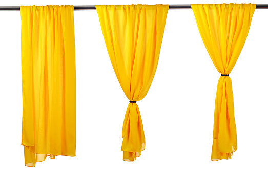 Vertical yellow satin curtains isolated on white background.