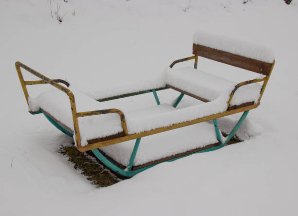 istock children's swing covered with fresh snow on the site 1149269206