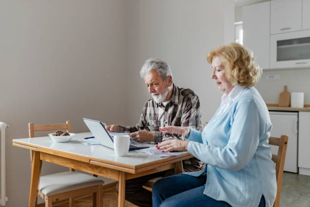 istock Serious mature couple calculating bills to pay 1149269797