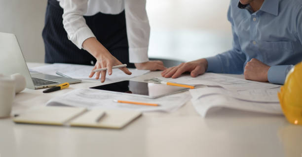 istock Architect designer engineer team colleagues working in blueprint in office 1149270439
