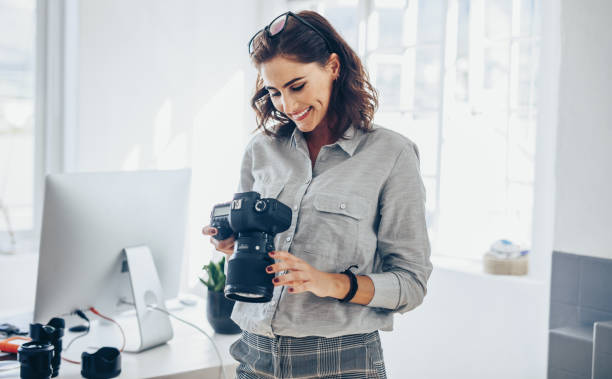istock Female photographer checking pictures 1149270715
