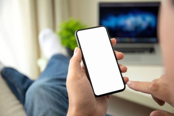 istock male hands holding phone with isolated screen in a room 1149270800